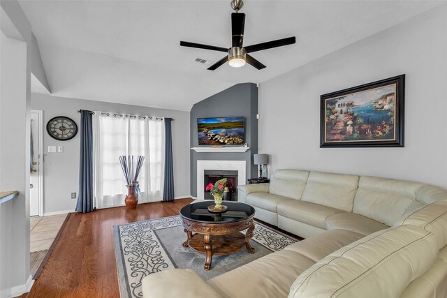 16222 Indian Cypress Dr, Cypress, TX 77429 - living room featuring vaulted ceiling, a ceiling fan, wood finished floors, a fireplace, and baseboards