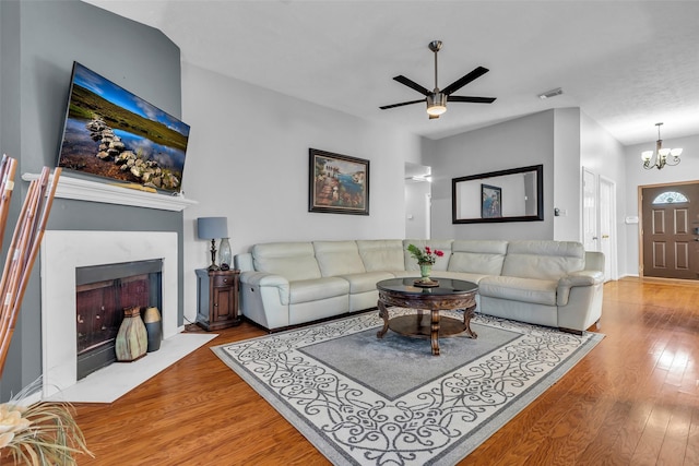 16222 Indian Cypress Dr, Cypress, TX 77429 - living area with wood finished floors, a high end fireplace, a ceiling fan, and a chandelier