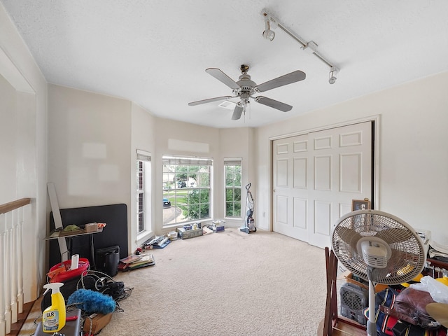 game room featuring carpet flooring, ceiling fan, and track lighting