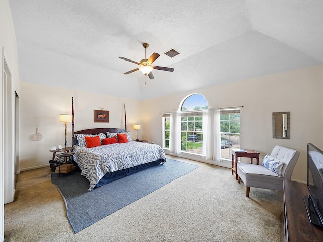 bedroom with carpet, vaulted ceiling, ceiling fan, and a textured ceiling