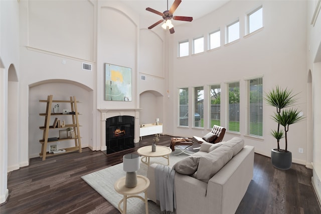 5422 Dalton Ranch Ln, Sugar Land, TX 77479 - living area with ceiling fan, a high ceiling, arched walkways, a fireplace, and dark wood-style floors