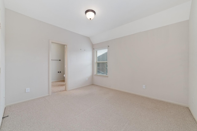 5422 Dalton Ranch Ln, Sugar Land, TX 77479 - empty room featuring light carpet, vaulted ceiling, and baseboards