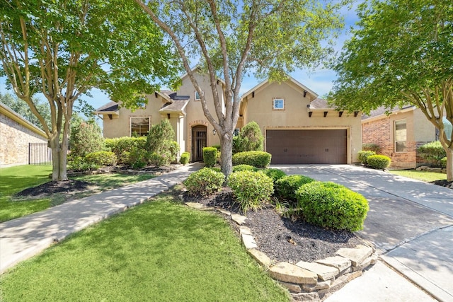 17715 Netherby Ln, Richmond, TX 77407 - view of front of house with stucco siding, concrete driveway, and a garage