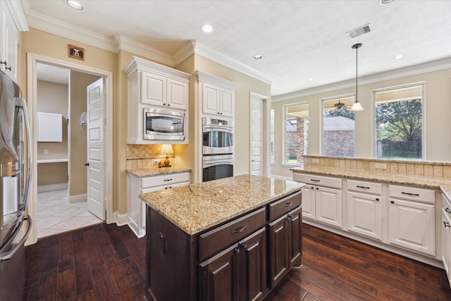 17715 Netherby Ln, Richmond, TX 77407 - kitchen featuring stainless steel appliances, white cabinets, dark brown cabinets, dark wood-style flooring, and recessed lighting