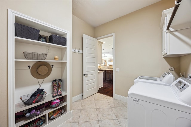 17715 Netherby Ln, Richmond, TX 77407 - washroom featuring cabinet space, separate washer and dryer, and baseboards