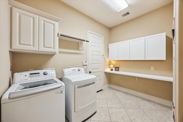 17715 Netherby Ln, Richmond, TX 77407 - laundry room with cabinet space, washer and dryer, baseboards, and light tile patterned floors