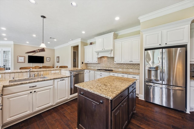 17715 Netherby Ln, Richmond, TX 77407 - kitchen featuring appliances with stainless steel finishes, a sink, white cabinetry, crown molding, and dark wood finished floors