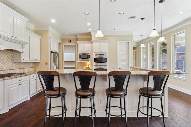 17715 Netherby Ln, Richmond, TX 77407 - kitchen with appliances with stainless steel finishes, dark wood-type flooring, recessed lighting, white cabinets, and a kitchen island with sink