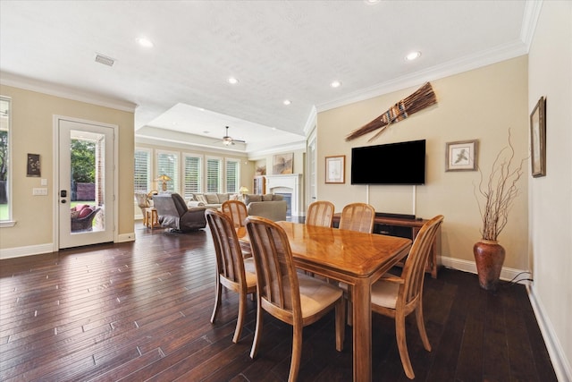 17715 Netherby Ln, Richmond, TX 77407 - dining room featuring baseboards, crown molding, recessed lighting, dark wood-style flooring, and a fireplace