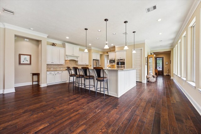 17715 Netherby Ln, Richmond, TX 77407 - kitchen featuring appliances with stainless steel finishes, dark wood finished floors, tasteful backsplash, white cabinets, and recessed lighting