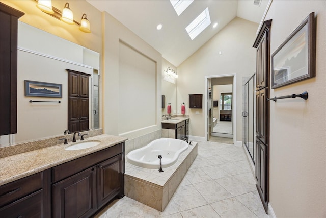 17715 Netherby Ln, Richmond, TX 77407 - bathroom with a skylight, two vanities, a garden tub, a stall shower, and tile patterned floors
