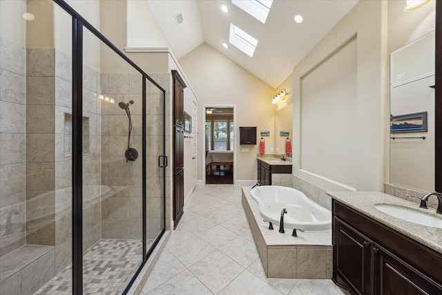 17715 Netherby Ln, Richmond, TX 77407 - full bath featuring two vanities, a jetted tub, a skylight, a shower stall, and lofted ceiling