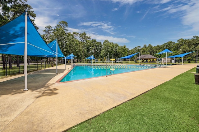 17022 Scuttle Way, Crosby, TX 77532 - community pool featuring fence, a patio, and view of scattered trees