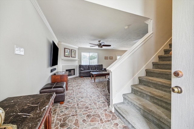 17022 Scuttle Way, Crosby, TX 77532 - stairs with crown molding, a ceiling fan, a fireplace, and stone finish floors