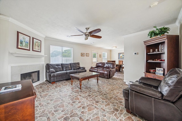 17022 Scuttle Way, Crosby, TX 77532 - living area featuring stone flooring, a ceiling fan, crown molding, and a fireplace