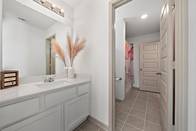 3306 Willow Fin Way, Richmond, TX 77406 - bathroom with vanity, tile patterned floors, baseboards, and a shower with shower curtain