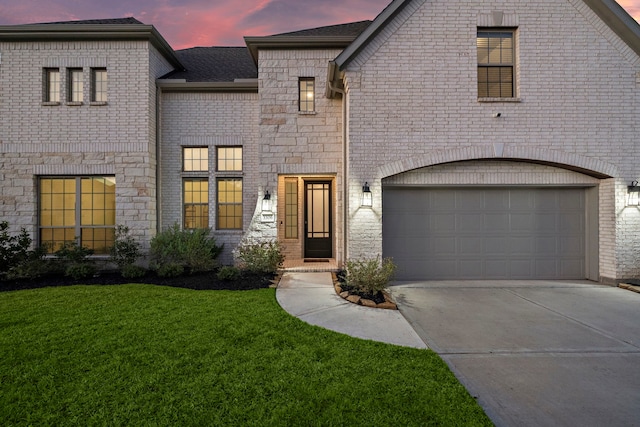 3306 Willow Fin Way, Richmond, TX 77406 - french country inspired facade featuring a garage, concrete driveway, a front yard, brick siding, and a shingled roof