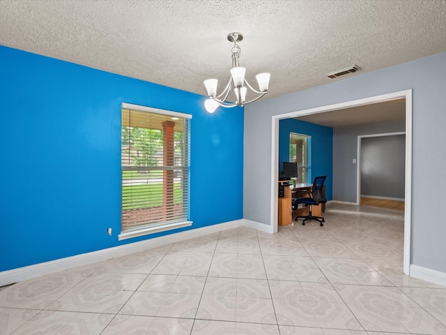 10218 Sagerock Dr, Houston, TX 77089 - empty room with a chandelier, baseboards, a textured ceiling, a desk, and light tile patterned floors