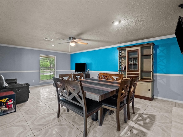 10218 Sagerock Dr, Houston, TX 77089 - dining space featuring ornamental molding, ceiling fan, baseboards, light tile patterned floors, and a textured ceiling