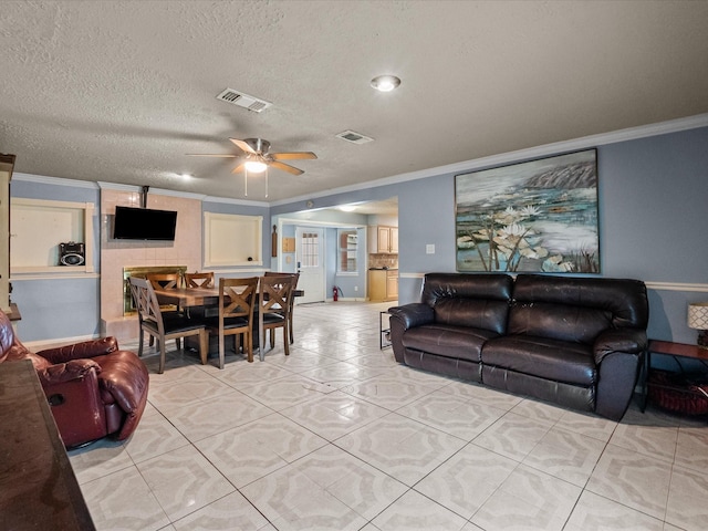 10218 Sagerock Dr, Houston, TX 77089 - living room with ornamental molding, a ceiling fan, a textured ceiling, and light tile patterned floors