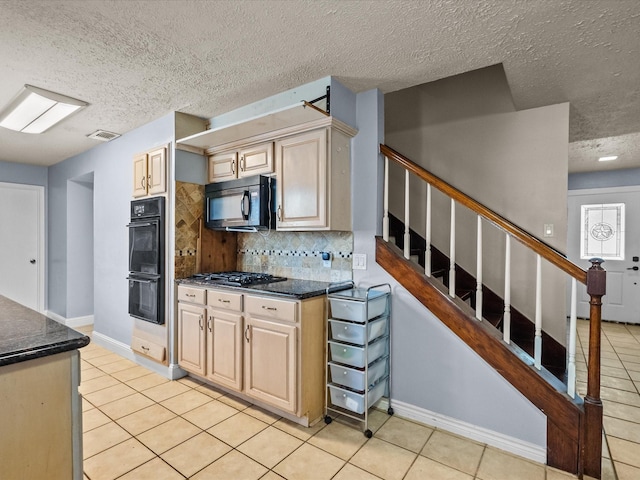 10218 Sagerock Dr, Houston, TX 77089 - kitchen with black appliances, light tile patterned floors, tasteful backsplash, a textured ceiling, and dark stone counters