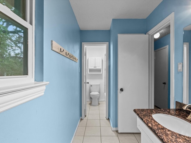 10218 Sagerock Dr, Houston, TX 77089 - bathroom featuring tile patterned flooring, toilet, vanity, baseboards, and a textured ceiling