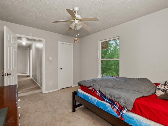 10218 Sagerock Dr, Houston, TX 77089 - carpeted bedroom with a textured ceiling, ceiling fan, and baseboards