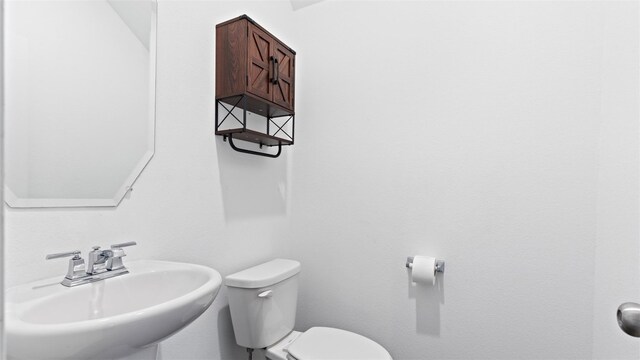 321 Lippizan Dr, Alvin, TX 77511 - half bathroom with a sink and toilet