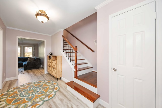 7906 Beaufort Dr, Spring, TX 77379 - entryway with light wood-style floors, stairs, ornamental molding, and baseboards