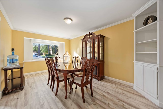 7906 Beaufort Dr, Spring, TX 77379 - dining area with light wood-style flooring, ornamental molding, and baseboards