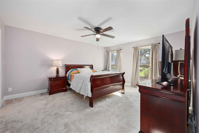 7906 Beaufort Dr, Spring, TX 77379 - bedroom with baseboards, light carpet, and a ceiling fan