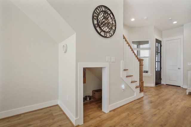 foyer featuring baseboards, light wood-style floors, stairway, and recessed lighting