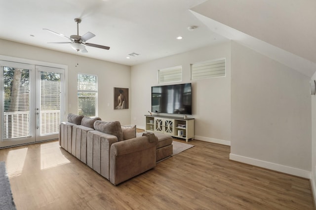 living area featuring light wood-type flooring, a ceiling fan, baseboards, recessed lighting, and french doors