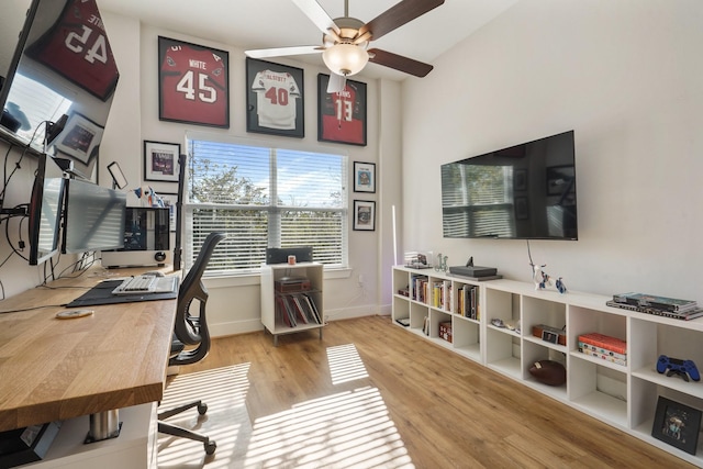office area featuring a ceiling fan, wood finished floors, and baseboards