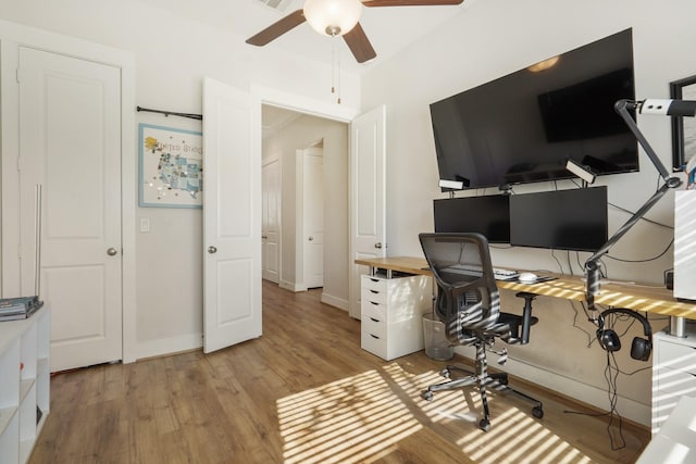 home office featuring ceiling fan, light wood finished floors, and baseboards