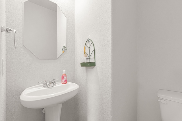 bathroom with toilet and a sink