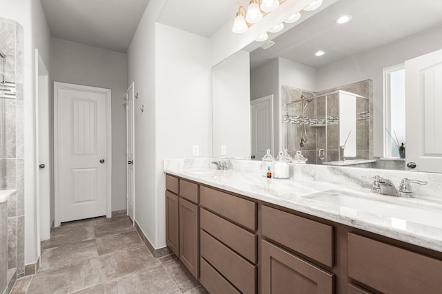 bathroom featuring a stall shower and double vanity