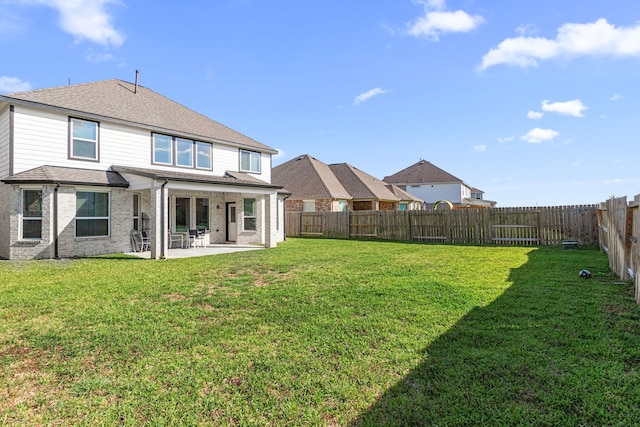 back of property with a patio, brick siding, and roof with shingles