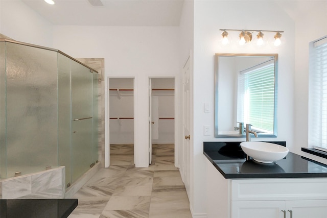 19415 Indian Hawthorn Dr, Houston, TX 77094 - bathroom with a shower stall, vanity, a spacious closet, and marble finish floors