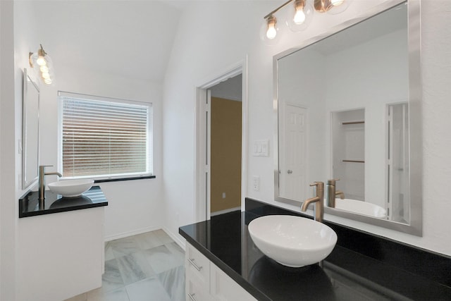 19415 Indian Hawthorn Dr, Houston, TX 77094 - bathroom with vanity, marble finish flooring, and vaulted ceiling