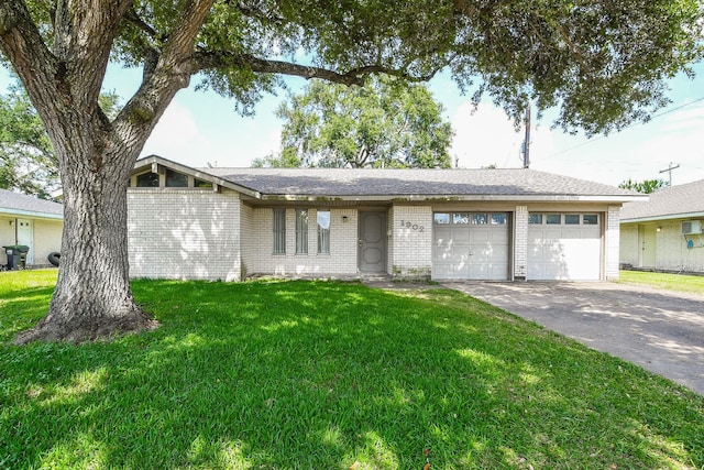 1902 S Memorial Ct, Pasadena, TX 77502 - view of front of property featuring brick siding, an attached garage, a front lawn, and driveway