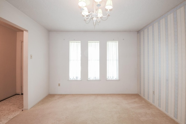 1902 S Memorial Ct, Pasadena, TX 77502 - carpeted spare room featuring a chandelier
