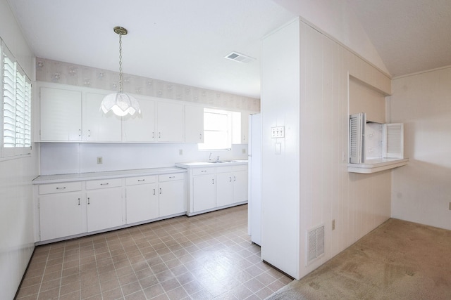 1902 S Memorial Ct, Pasadena, TX 77502 - kitchen featuring white cabinets, light countertops, and pendant lighting