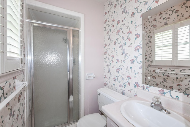 1902 S Memorial Ct, Pasadena, TX 77502 - bathroom featuring wallpapered walls, a shower stall, toilet, and vanity