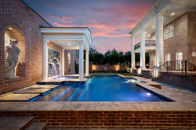view of pool with a pool with connected hot tub