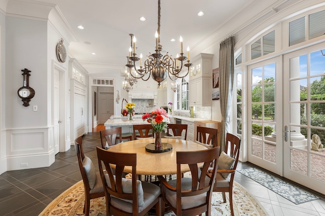 dining area with recessed lighting, a chandelier, crown molding, dark tile patterned floors, and a decorative wall