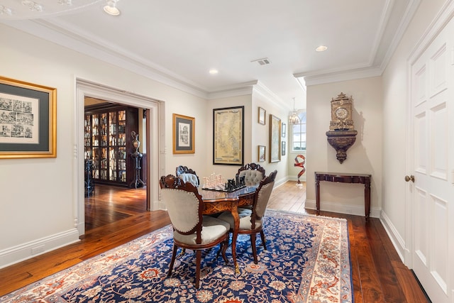 dining room with hardwood / wood-style floors, crown molding, recessed lighting, and baseboards