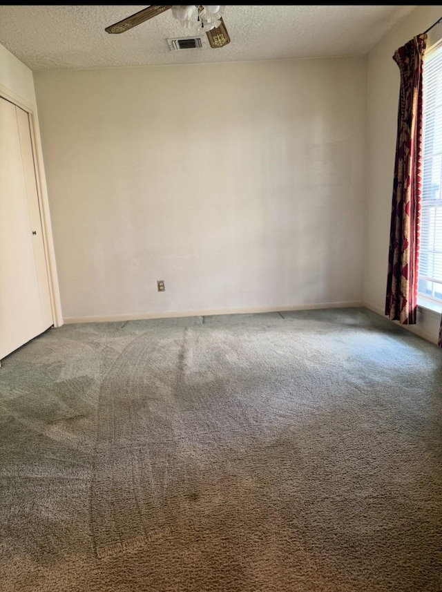 13424 Castilian Dr Unit 113, Houston, TX 77015 - unfurnished room featuring carpet, healthy amount of natural light, ceiling fan, and a textured ceiling