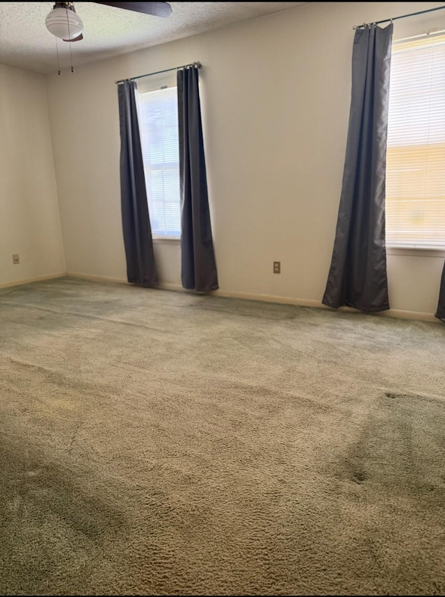 13424 Castilian Dr Unit 113, Houston, TX 77015 - carpeted spare room featuring a textured ceiling, ceiling fan, and baseboards