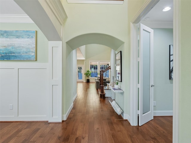 4635 Beech St, Bellaire, TX 77401 - corridor featuring arched walkways, dark wood-style flooring, ornamental molding, and baseboards